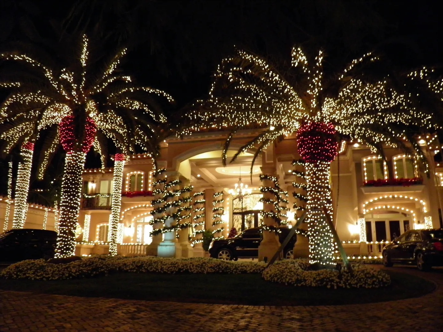 Home outlined with warm white Christmas lights at dusk