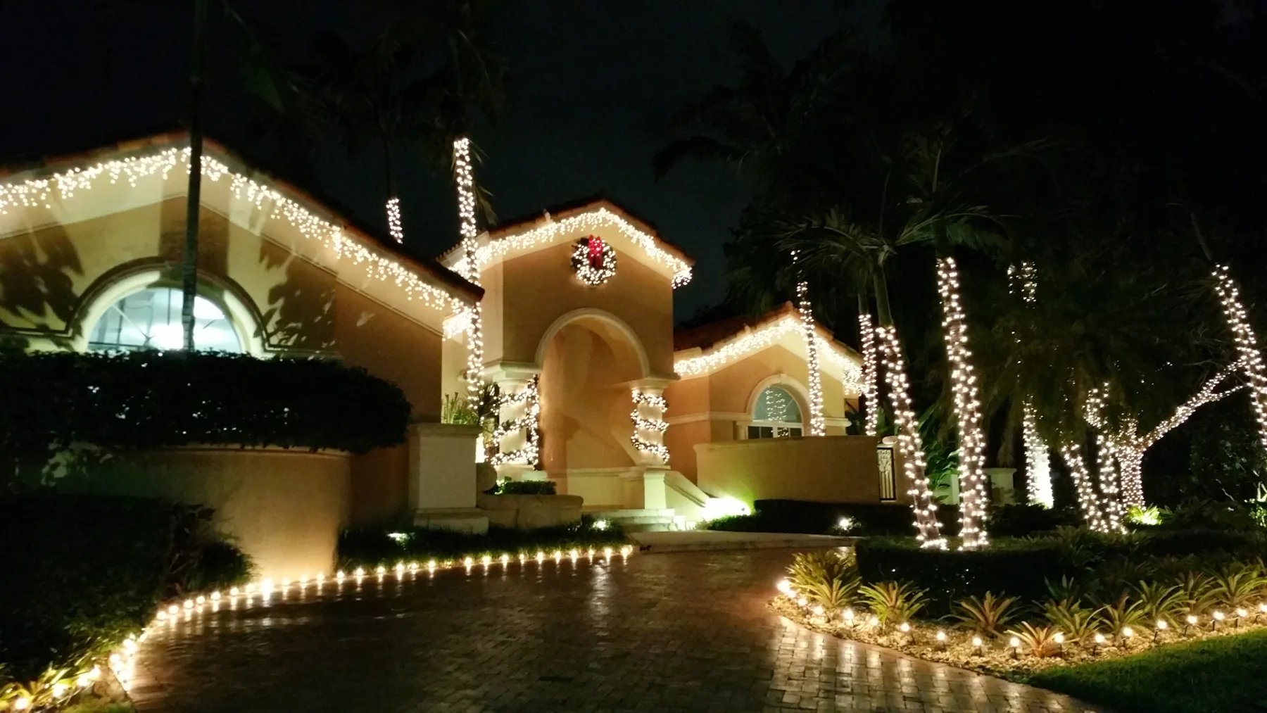 Home facade and trees lit for the Christmas season