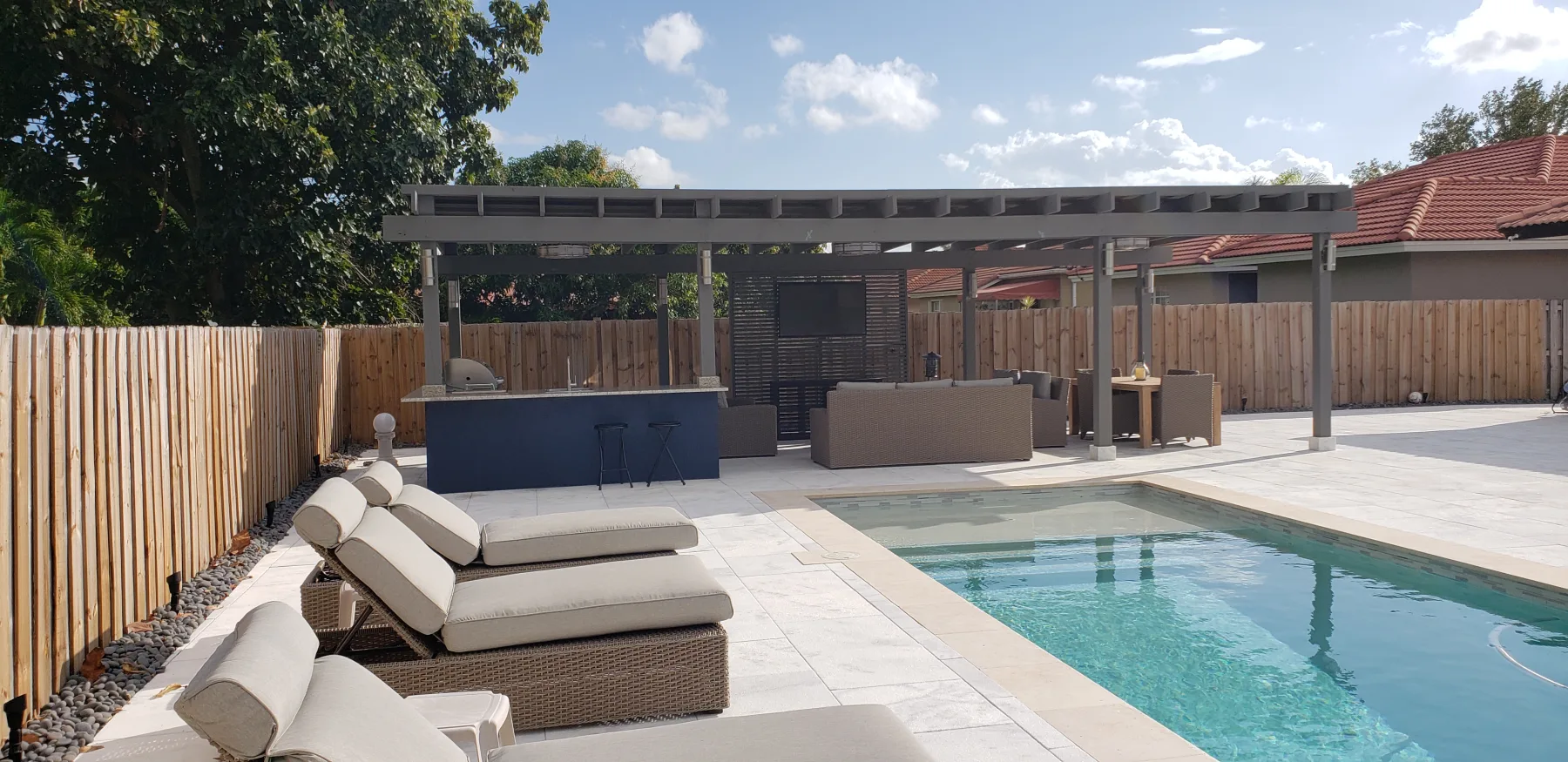 Lounge seating along the pool and shaded dining area